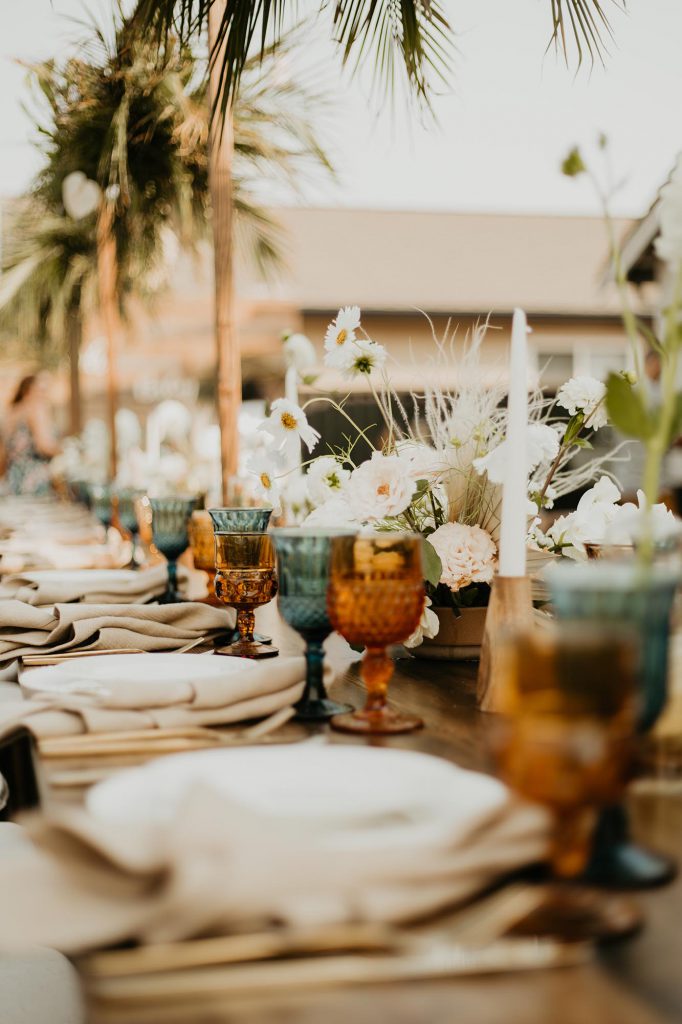neutral tablescape with blue and amber goblets