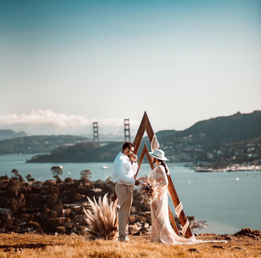 bride and groom with golden gate bridge in the background